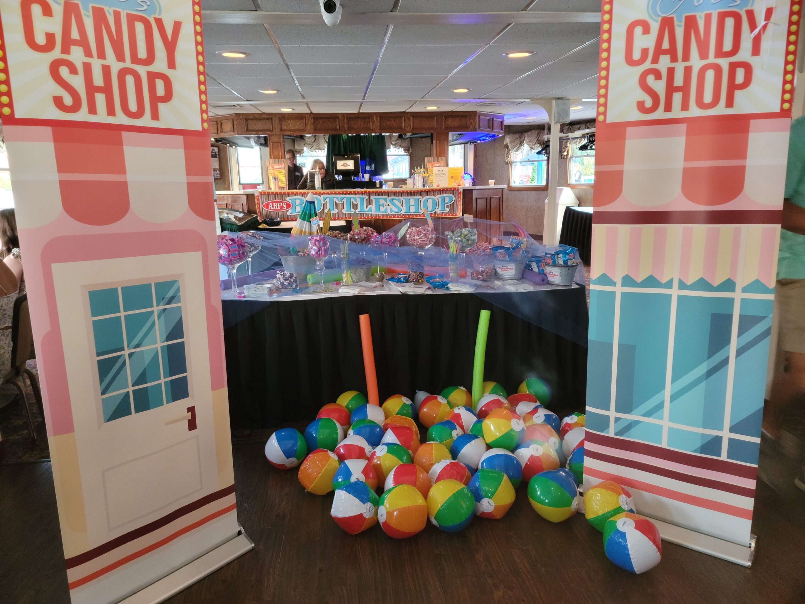 a candy shop display with lots of balls on the floor