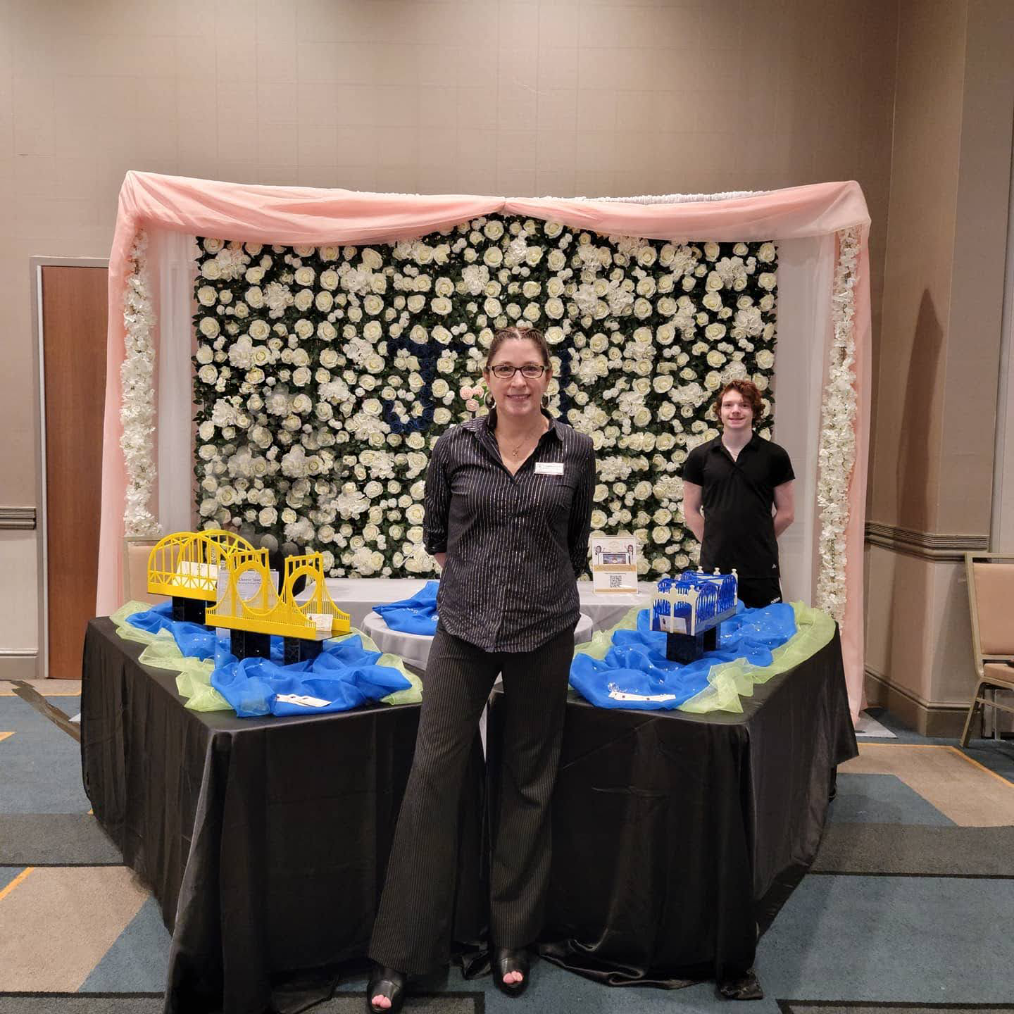 two women standing in front of a table with legos on it