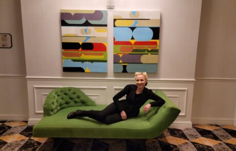 a woman is sitting on a green couch