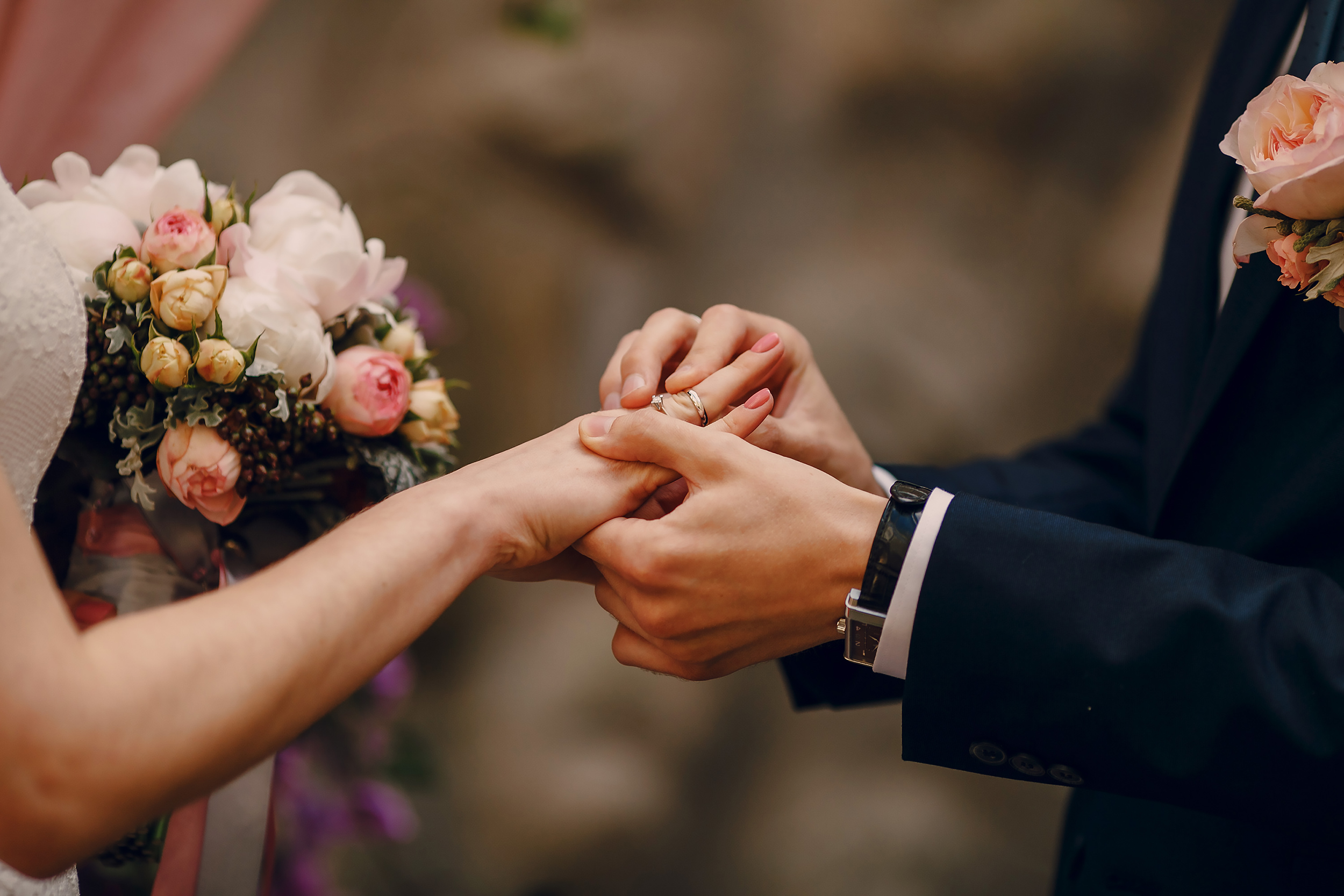 a bride and groom holding hands during their wedding ceremony