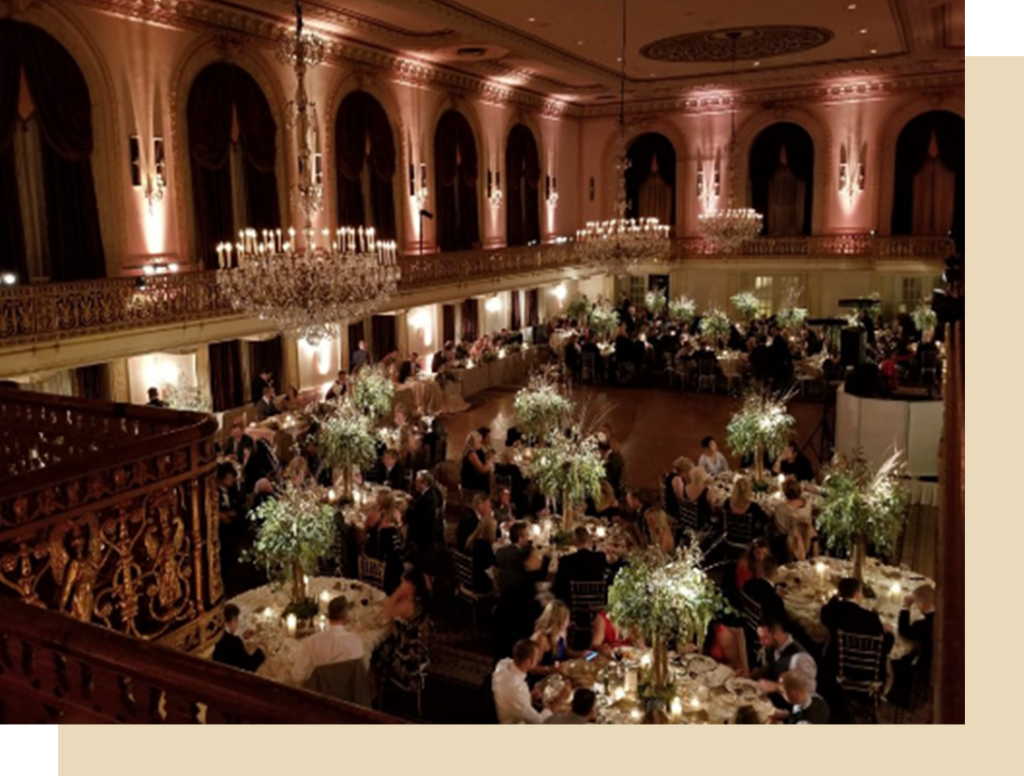 a large room filled with tables and chandeliers