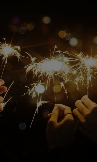 two people holding sparklers in their hands